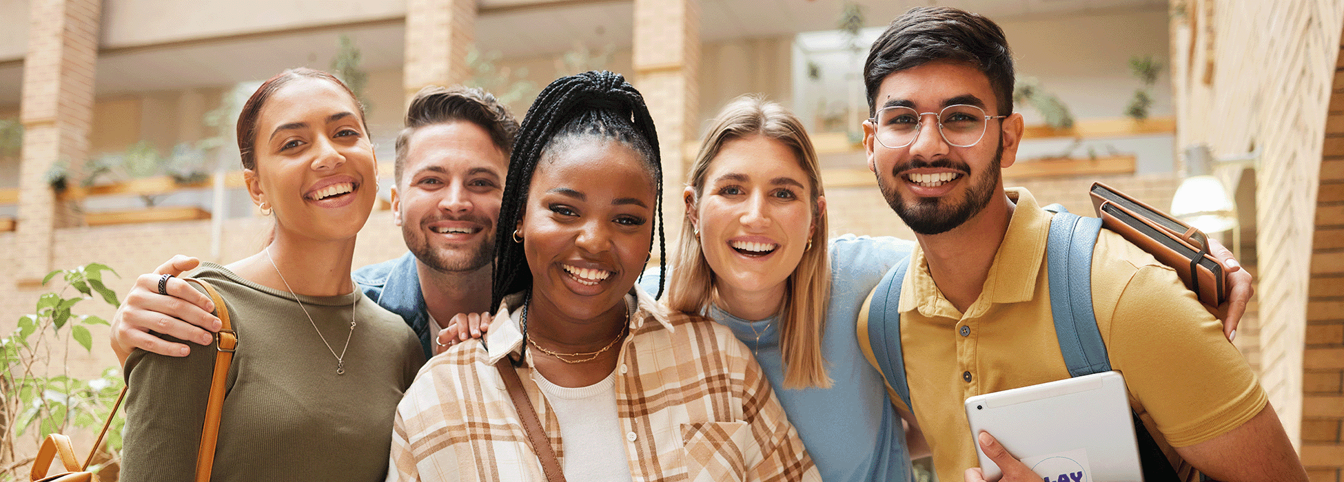 diverse group of young adults looking into camera